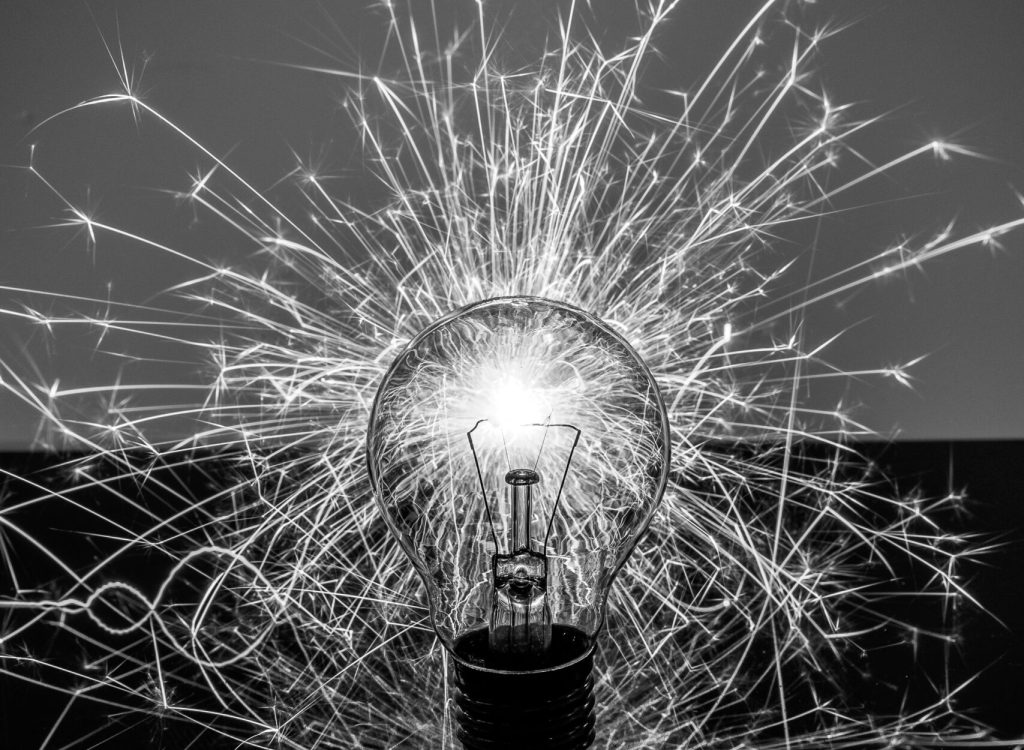 A vertical greElectrical Poweryscale sh of a sparkling light bulb - concept: a new idea, innovation